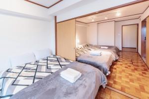 东京四谷松本館ビル的一间客房内配有两张床的房间