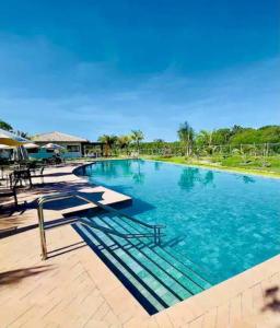 普拉亚多INCRIVEL apartamento com vista lago!的蓝色海水大型游泳池