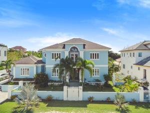 拿骚Blu Diamond Luxury Estate Home的白色栅栏的大型蓝色房屋