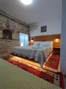 吉诺卡斯特Guest House Salaria的一间卧室设有一张大床和石墙