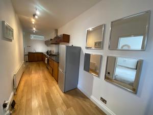 伦敦Stylish Traveller's Heaven的厨房配有冰箱和一些窗户。
