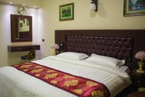 安曼Qaser Al-Sultan Hotel Suites的一间卧室配有一张大床和镜子