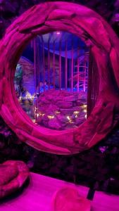 阿兹布鲁克La Terrasse Des Spas的一间设有石墙和紫色灯的房间