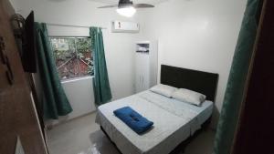 瓜拉派瑞Pousada Moinho D'água的一间卧室配有一张带蓝色枕头的床