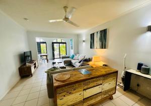 棕榈湾Appartment in Palm Cove的客厅配有沙发和桌子