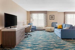 格林维尔Comfort Inn & Suites Greenville Near Convention Center的酒店的客房配有平面电视和家具。