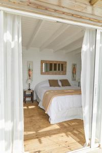 何塞伊格纳西奥Laguna Garzón Lodge的一间卧室配有一张带白色床单的大床