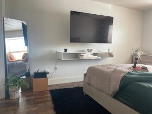 奥斯汀Mella House的一间卧室配有一张床和一台平面电视