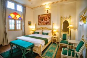 斋浦尔The Royal Hermitage - Best Luxury Boutique Hotel Jaipur的卧室配有一张床和一张桌子及椅子