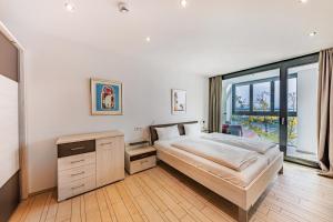 腓特烈港艾卡海滨生活酒店的一间卧室设有一张床和一个大窗户
