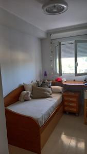 卡耐特蒂贝兰格CANET PLAYA MAGNIFICO APTO FAMILIAR con PISCINA y GARAJE的一间卧室配有一张大床、书桌和窗户