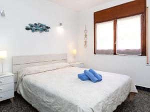 霍斯皮塔勒·德尔英福Apartment Beausoleil by Interhome的一间卧室配有一张带两个蓝色枕头的床