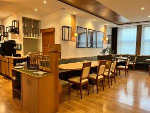 SpaichingenHotel Restaurant Kreuz Spaichingen的一间带长桌和椅子的餐厅