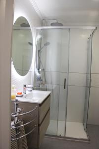 卡斯卡伊斯ARRUDA LUXURY APARTMENT with AC的浴室配有盥洗盆和带镜子的淋浴