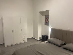 科洛皮奥Leo's Apartments的一间白色卧室,配有床和橱柜