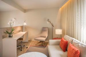 里斯本里斯本自由大道NH集团酒店的带沙发和书桌的客厅