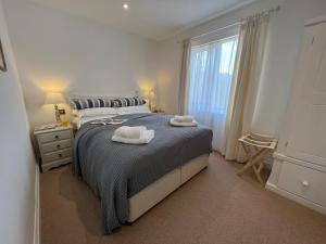 BentleyDell View - Charming & Cosy的一间卧室配有一张床,上面有两条毛巾