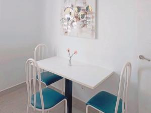 拉拉古纳Live La Laguna Gracia的一张带两把椅子的白色桌子和花瓶