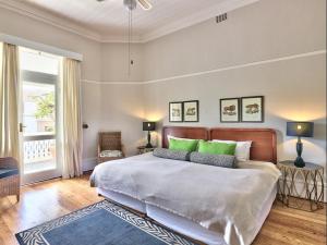 开普敦开普敦殖民地旅馆的一间卧室配有一张带绿色枕头的大床