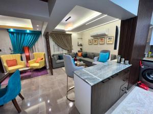 开罗luxury flat with garden and private entrance شقة فاخرة بحديقة و مدخل خاص的客厅配有色彩缤纷的椅子和沙发