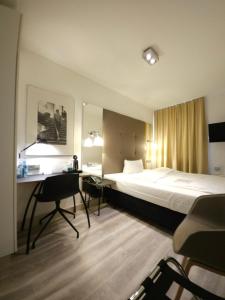 汉诺威艾玛迪斯酒店的配有一张床和一张书桌的酒店客房