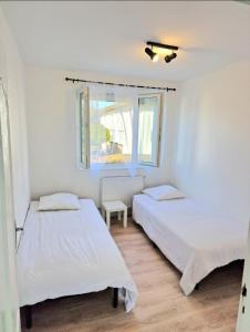 欧里亚克Maison à Aurillac - 3 chambres - Arrivée autonome的白色客房的两张床,设有窗户