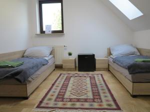 CholerzynAirSpot Balice的地板上带地毯的客房内的两张床