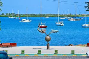 拉巴斯NEW Comfy Stay with Pool Onsite Steps from Malecón的水球上女人和鱼的雕像
