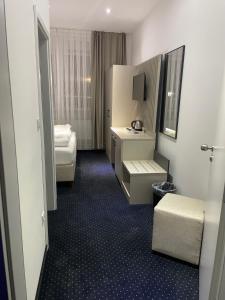 曼兴Gastpark Hotel的酒店客房设有一间带一张床和一张书桌的卧室