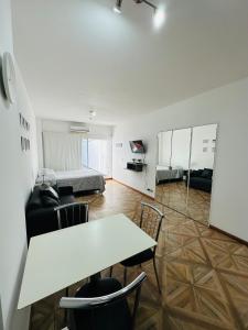 布宜诺斯艾利斯Apartamento Avenida del Libertador的客厅配有桌椅和1张床