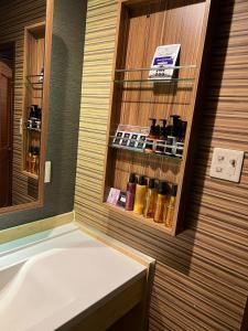 Minatomachiホテルアシュエル的带浴缸和瓶子架的浴室