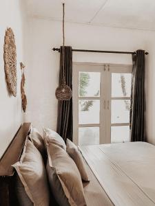 阿杭格默Mermaid Beach的卧室配有带枕头的床铺和窗户。