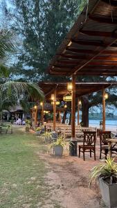 Ban Ai DaoLanta Villa Resort的公园内带长椅和桌子的木制凉亭