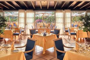 马斯帕洛马斯格朗卢悦君悦滨海大酒店的用餐室设有桌椅和窗户。