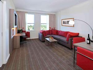 格伦韦弗利墨尔本诺富特格林威福利酒店的客厅配有沙发和桌子