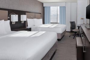 史泰登岛Fairfield Inn & Suites by Marriott New York Staten Island的酒店客房配有两张床和一张书桌