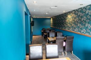 伍斯特塞文河景酒店的一间拥有蓝色墙壁和桌椅的用餐室