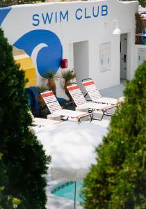 圣达菲艾尔瑞库尔特酒店的一组椅子坐在游泳俱乐部前