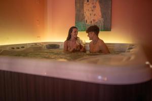 里米尼杜塞尔多夫酒店的坐在浴缸里的男人和女人