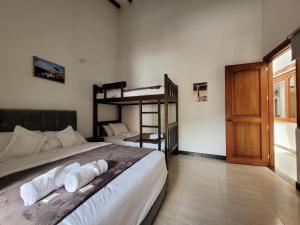 莱瓦镇HOTEL ALTIPLANO VILLA DE LEYVA的一间卧室设有两张双层床和一扇门