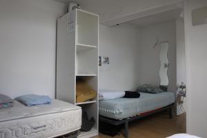 里尔Appartement spacieux Lille的一间设有床铺和白色橱柜的房间