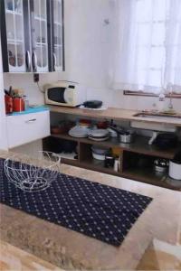 大普拉亚Seu Cantinho na Vila Tupi 3 Dormitórios的厨房配有水槽和台面
