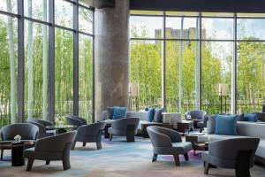 临安杭州临安万豪酒店的大堂设有桌椅和大窗户。