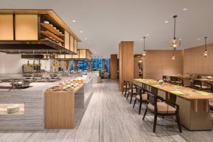 无锡无锡鲁能万怡酒店的开放式厨房和带桌椅的用餐室