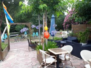 奥雷龙圣乔治Résidence Fleur des Pins - Gites & Chambres d'Hôtes的一个带桌椅和遮阳伞的庭院