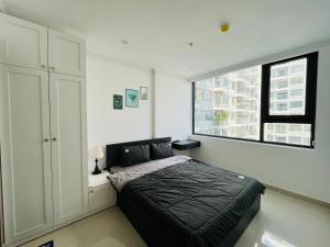 Thôn Văn DươngAn homestay, apartment Nera Huế的一间卧室设有一张黑色的床和一个窗户。