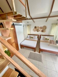 圣胡安Casa Maria at Bigang Munti的一间带两张床和楼梯的客厅