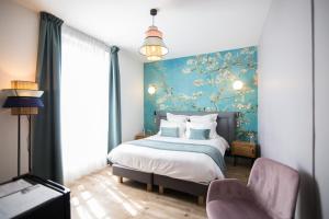 瓦兹河畔欧韦Hotel des Iris的一间卧室设有一张床和蓝色的墙壁