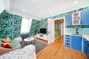 伦敦Crashpads Shoreditch Brick Lane Mini Lofts的客厅拥有蓝色和绿色的壁纸