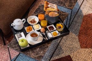 科尔马Hotel Le Colombier的桌上的早餐盘